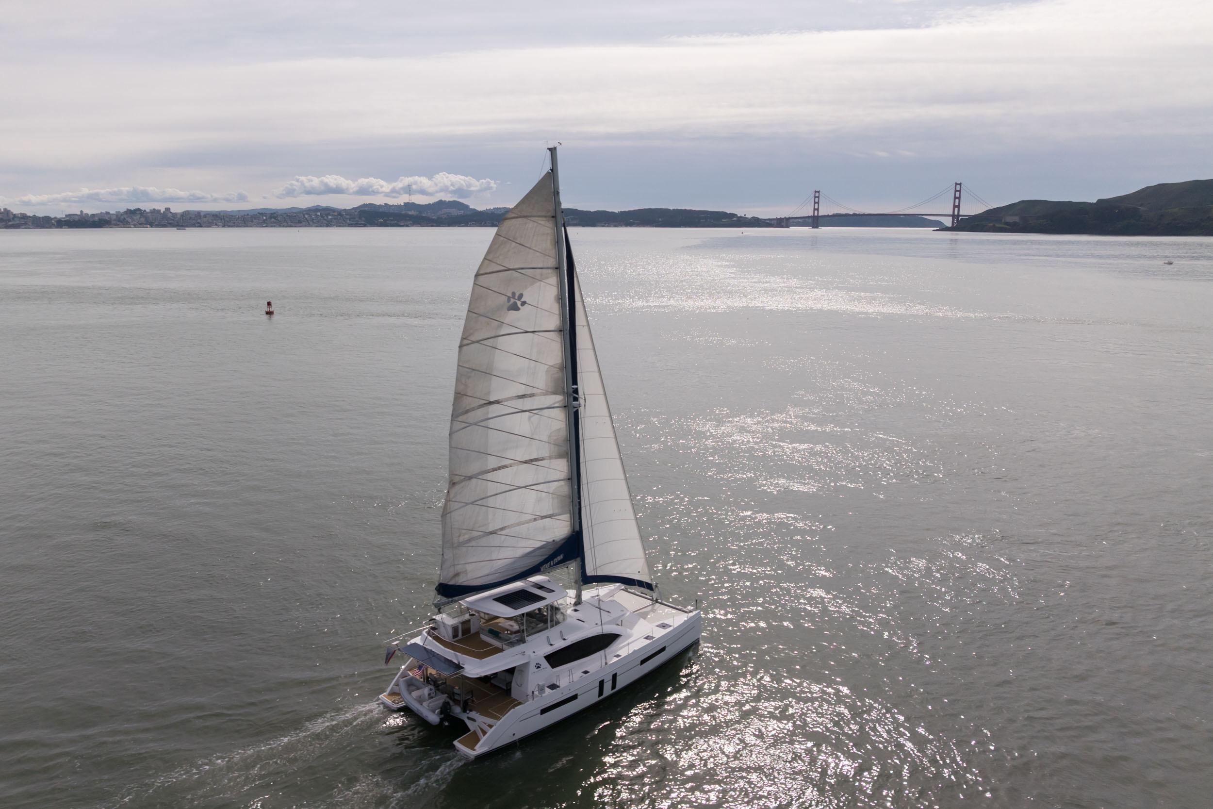 Sailing catamaran Leopard 58, 2015 model, cruising near Golden Gate Bridge on a calm day.