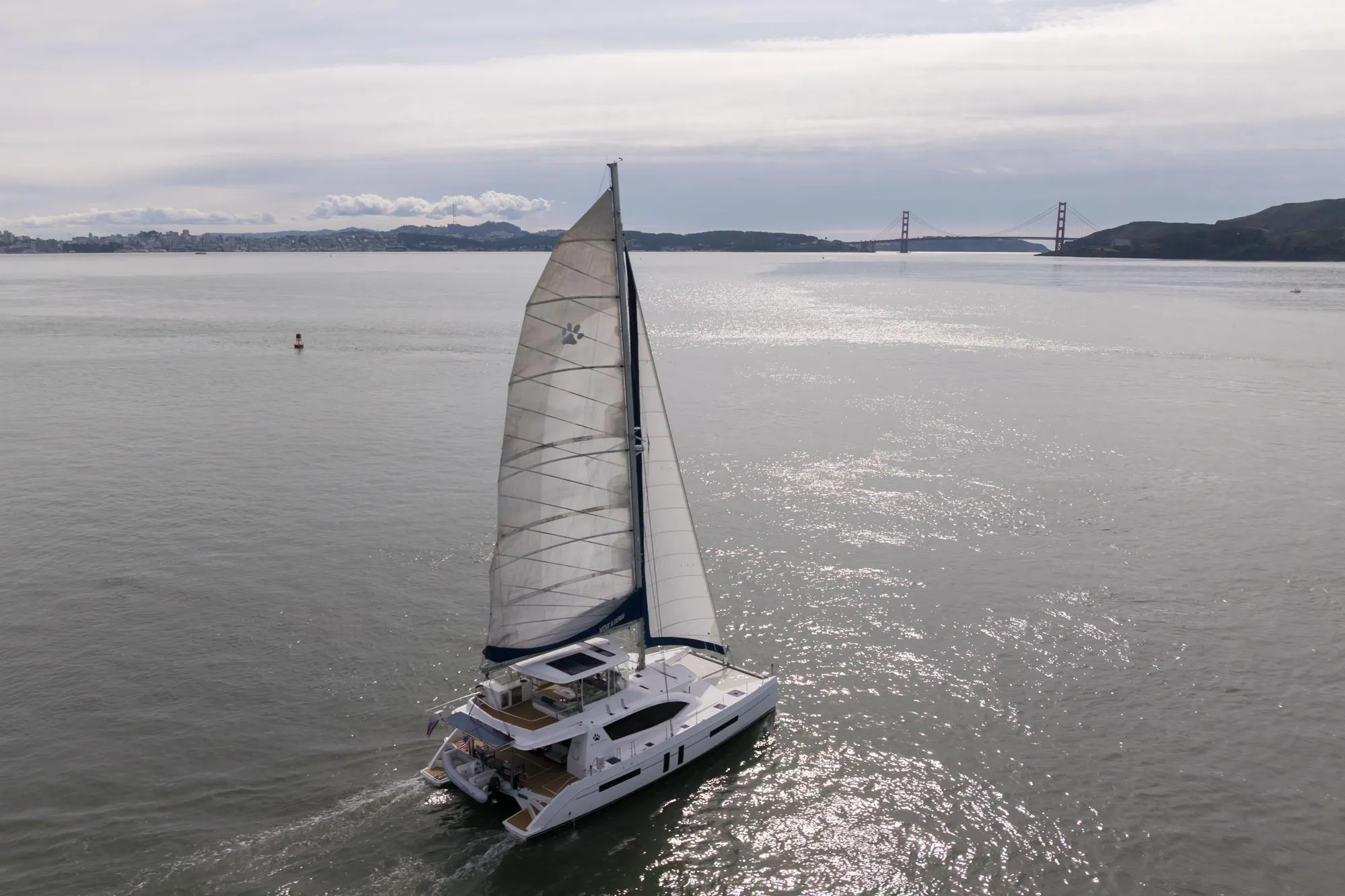 Sailing catamaran Leopard 58, 2015 model, cruising near Golden Gate Bridge on a calm day.