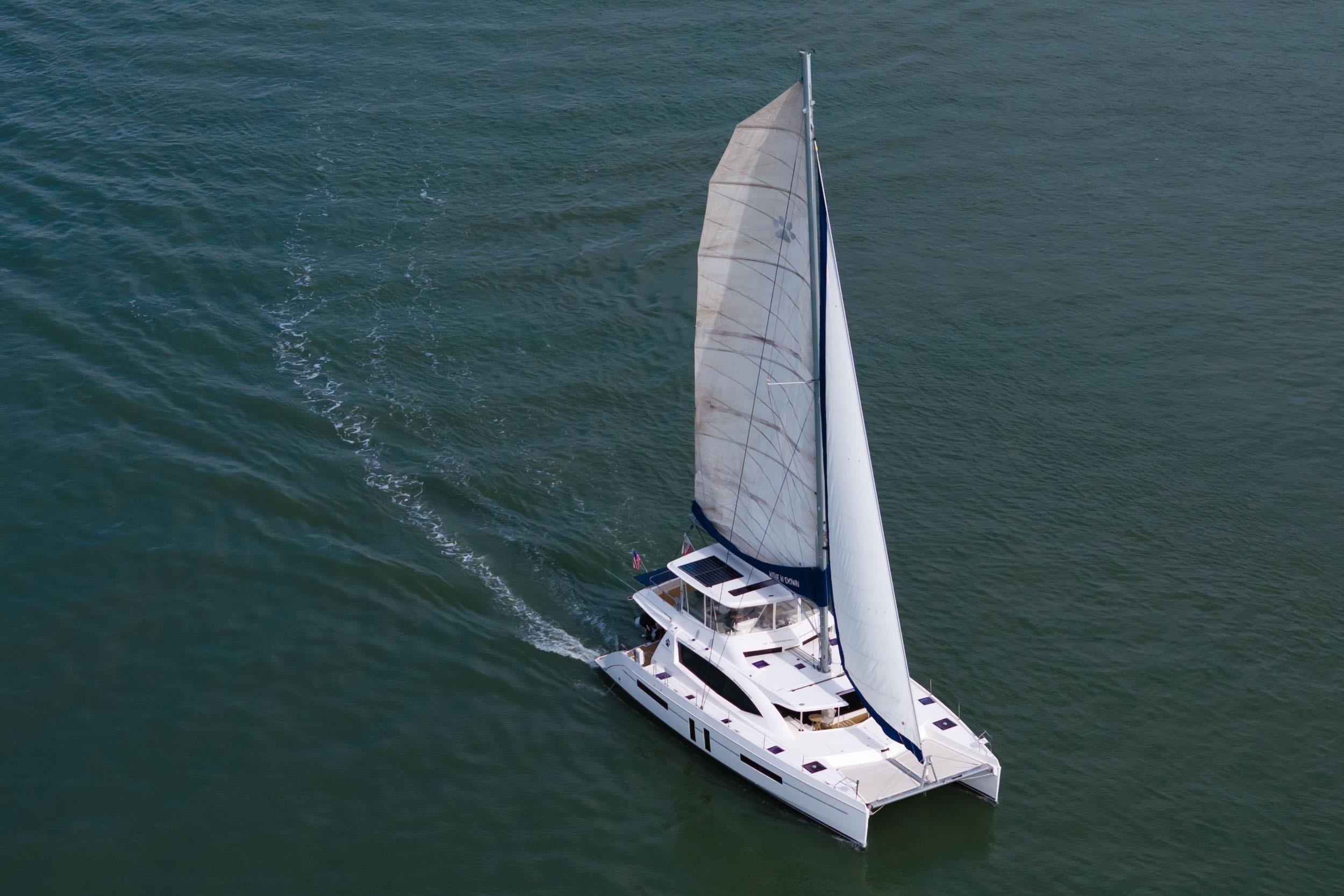 Aerial view of 2015 Leopard 58 catamaran sailing on open water.