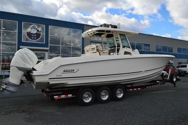  Yacht Photos Pics 2018 Boston Whaler 330 Outrage boat on trailer outside dealership.