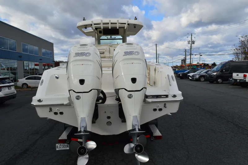  Yacht Photos Pics 2018 Boston Whaler 330 Outrage with twin 350 engines, parked outdoors.