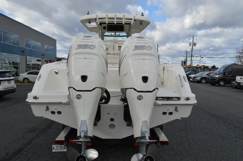  Yacht Photos Pics 2018 Boston Whaler 330 Outrage with twin 350 engines, parked outdoors.