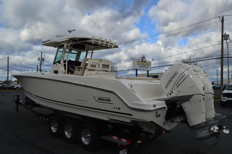  Yacht Photos Pics 2018 Boston Whaler 330 Outrage boat on trailer, cloudy sky background.