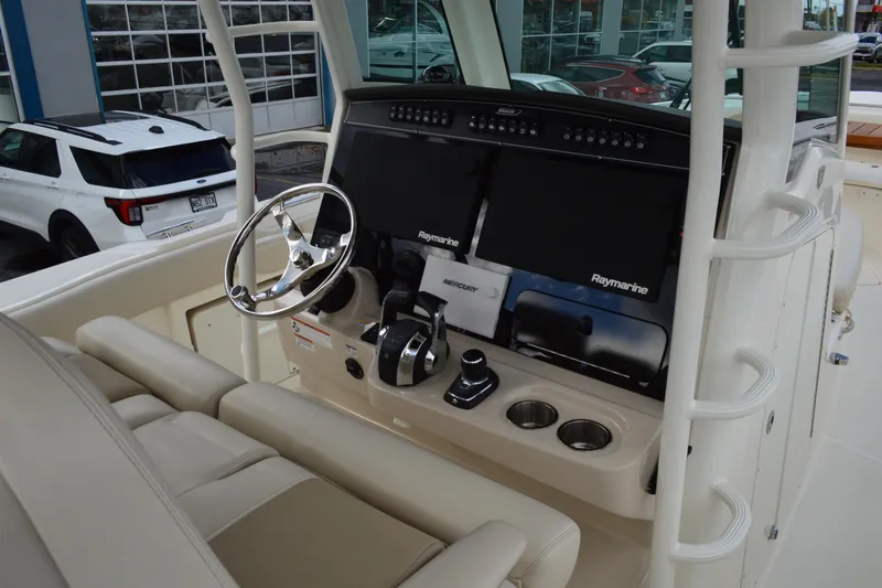  Yacht Photos Pics 2018 Boston Whaler 330 Outrage helm with Raymarine displays and steering wheel.