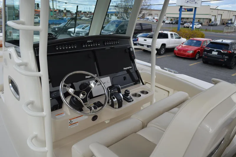  Yacht Photos Pics 2018 Boston Whaler 330 Outrage helm with steering wheel and navigation displays.