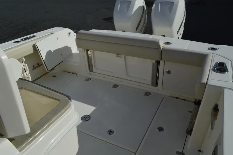  Yacht Photos Pics 2018 Boston Whaler 330 Outrage boat interior with seating and storage compartments.