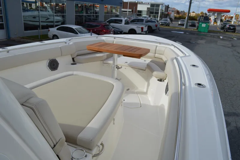  Yacht Photos Pics 2018 Boston Whaler 330 Outrage boat interior with seating and wooden table.
