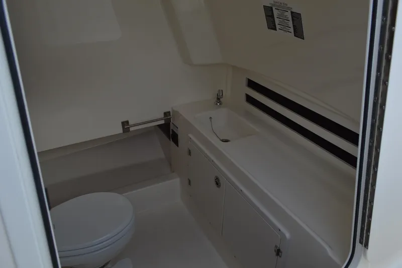  Yacht Photos Pics 2018 Boston Whaler 330 Outrage interior bathroom with sink and toilet.