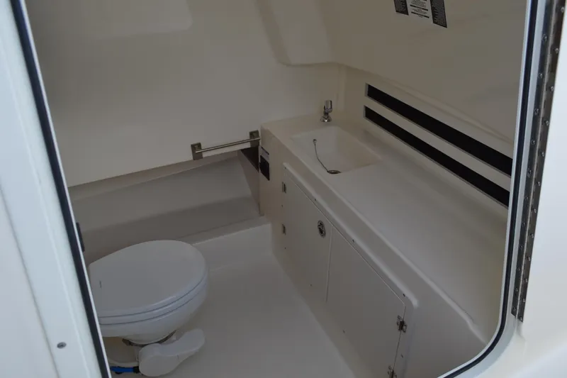  Yacht Photos Pics 2018 Boston Whaler 330 Outrage boat interior with toilet and sink.