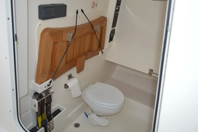  Yacht Photos Pics 2018 Boston Whaler 330 Outrage boat interior with compact marine toilet.