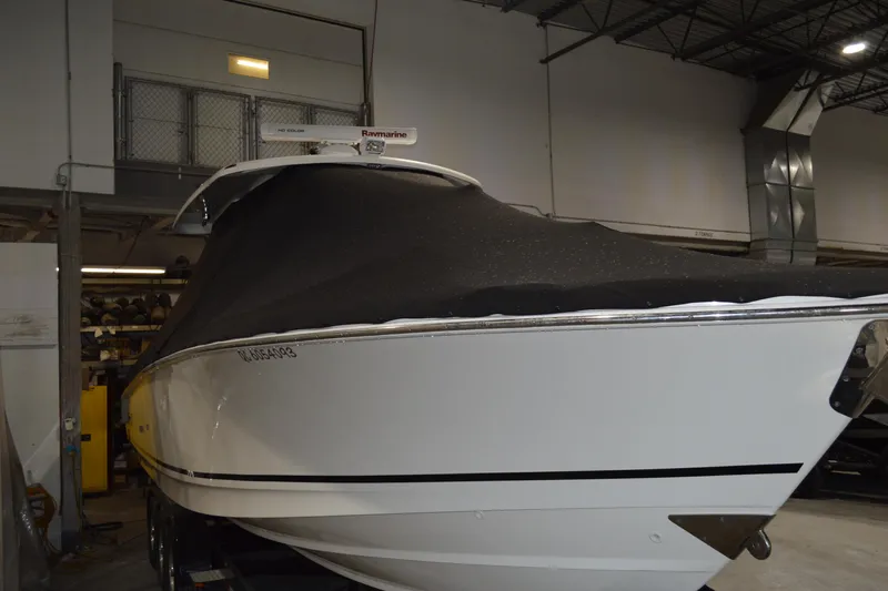  Yacht Photos Pics 2018 Boston Whaler 330 Outrage boat with cover in indoor storage.