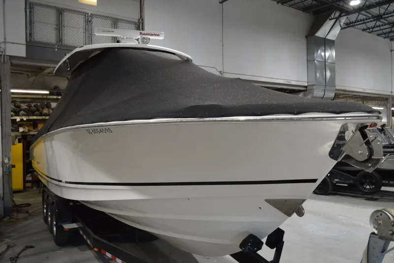  Yacht Photos Pics 2018 Boston Whaler 330 Outrage boat with cover in indoor storage.