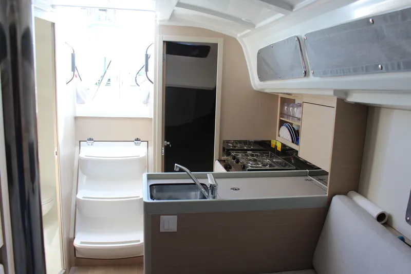 Scraft 2 Yacht Photos Pics Interior of 2022 Beneteau Oceanis 30.1 yacht, featuring modern kitchen and compact design.