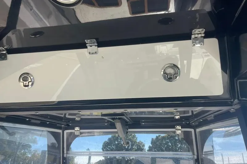  Yacht Photos Pics 2023 Cobia 320 Center Console boat interior storage compartment with secure latches.