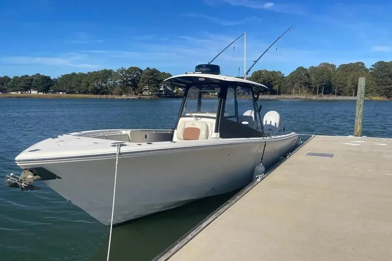  Yacht Photos Pics 2023 Cobia 320 Center Console boat docked on a sunny day.