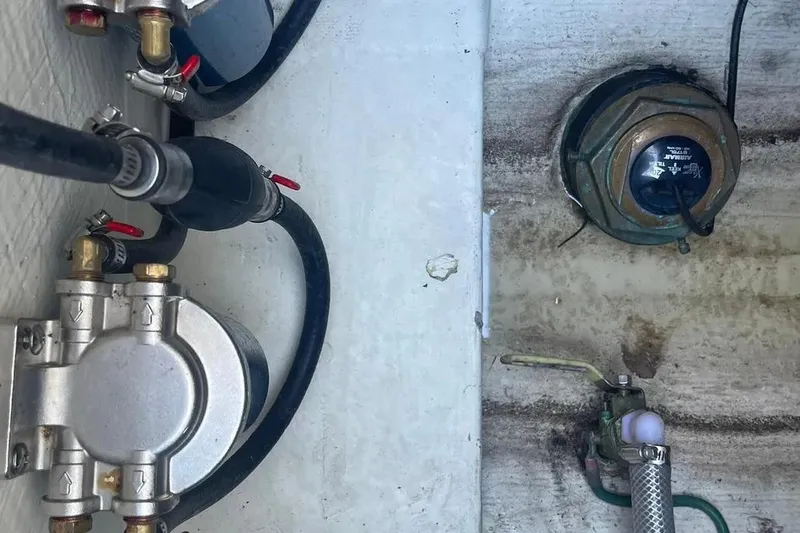  Yacht Photos Pics 2023 Cobia 320 Center Console boat components, featuring fuel lines and connectors.