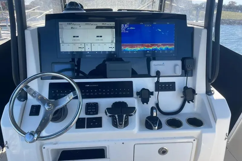  Yacht Photos Pics 2023 Cobia 320 Center Console helm with Garmin displays and controls.