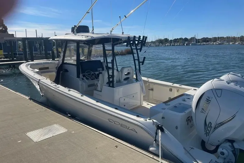  Yacht Photos Pics 2023 Cobia 320 Center Console boat docked by the water.