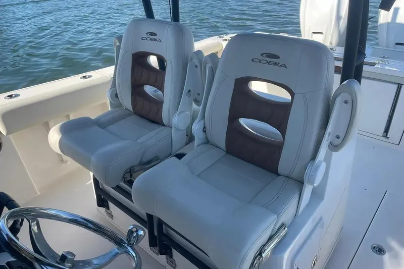  Yacht Photos Pics 2023 Cobia 320 Center Console boat seats with ocean backdrop.