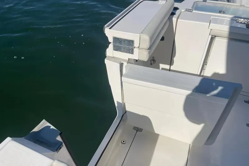  Yacht Photos Pics 2023 Cobia 320 Center Console boat with open transom door on calm water.