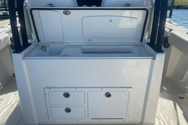  Yacht Photos Pics 2023 Cobia 320 Center Console boat interior with storage compartments and sink.