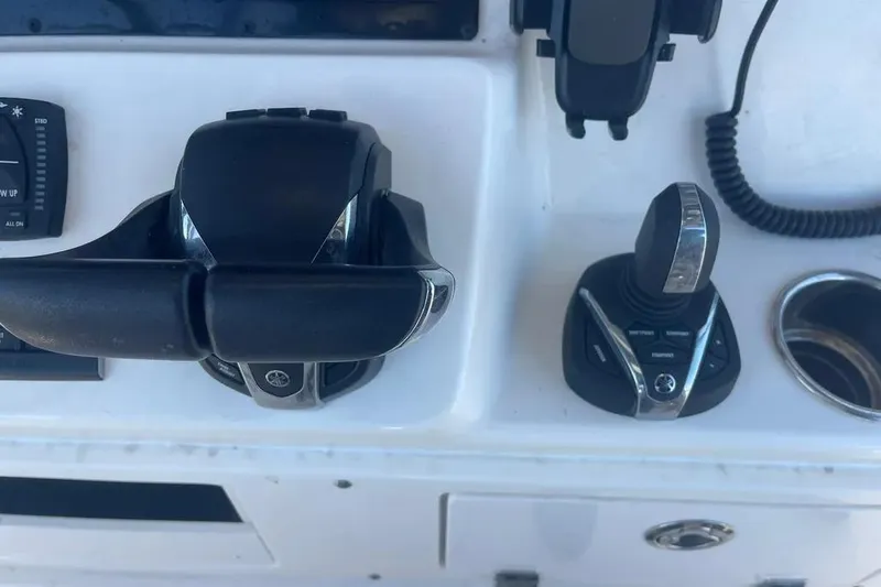  Yacht Photos Pics 2023 Cobia 320 Center Console boat controls and joystick on dashboard.