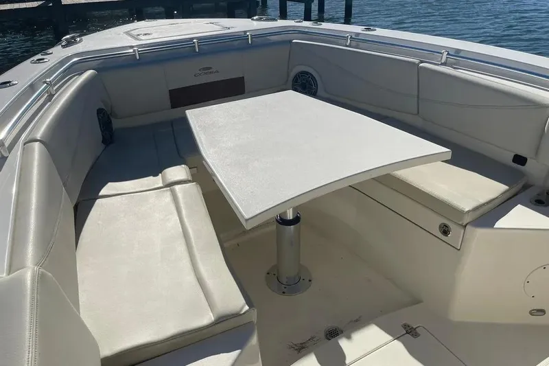  Yacht Photos Pics 2023 Cobia 320 Center Console boat interior with seating and table.