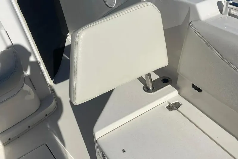  Yacht Photos Pics 2023 Cobia 320 Center Console boat seat detail, featuring white upholstery and sleek design.