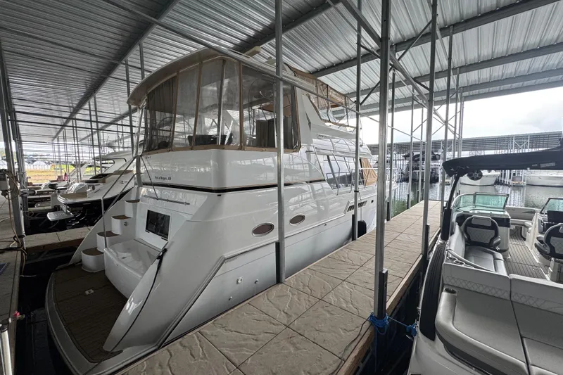  Yacht Photos Pics 2000 Carver 406 Aft Cabin Motor Yacht docked in a covered marina.
