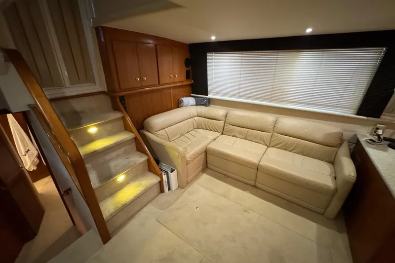  Yacht Photos Pics Interior of 2000 Carver 406 Aft Cabin Motor Yacht with beige leather sofa and carpeted stairs.