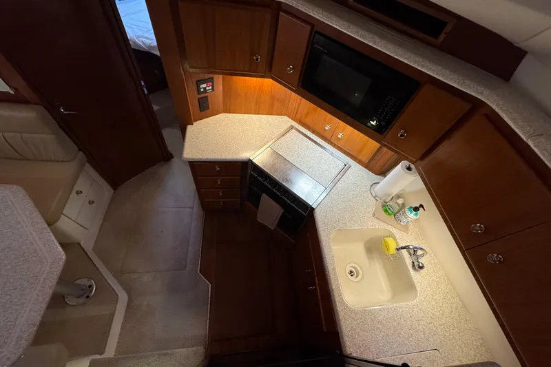  Yacht Photos Pics Interior of 2000 Carver 406 Aft Cabin Motor Yacht kitchen with sink and microwave.