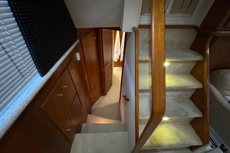  Yacht Photos Pics Interior of 2000 Carver 406 Aft Cabin Motor Yacht with carpeted stairs and wooden cabinetry.