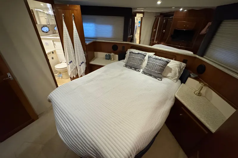  Yacht Photos Pics Luxurious bedroom in 2000 Carver 406 Aft Cabin Motor Yacht with ensuite bathroom.