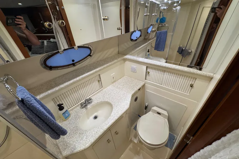  Yacht Photos Pics Bathroom of 2000 Carver 406 Aft Cabin Motor Yacht with sink, toilet, and mirror.