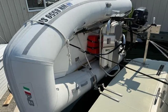 Naut On Call Yacht Photos Pics Inflatable boat mounted on 2016 Back Cove 34, docked with visible outboard motor.