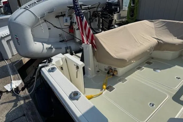 Naut On Call Yacht Photos Pics 2016 Back Cove 34 boat with American flag and covered seating area.