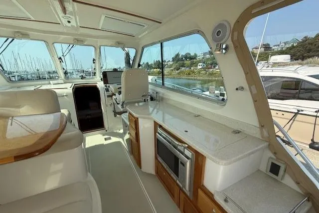 Naut On Call Yacht Photos Pics Interior of 2016 Back Cove 34 yacht with modern kitchen and seating area.