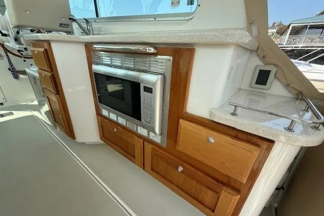 Naut On Call Yacht Photos Pics 2016 Back Cove 34 yacht interior with microwave and wooden cabinetry.