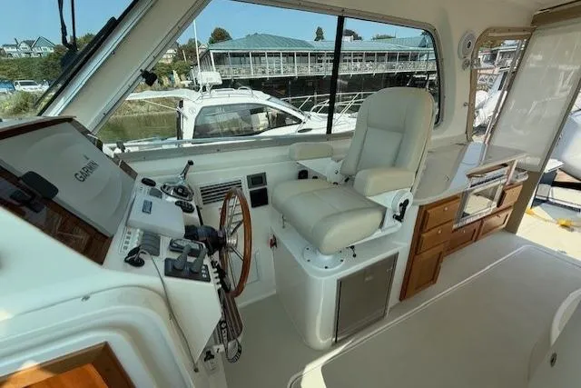 Naut On Call Yacht Photos Pics 2016 Back Cove 34 boat interior with helm, steering wheel, and navigation equipment.