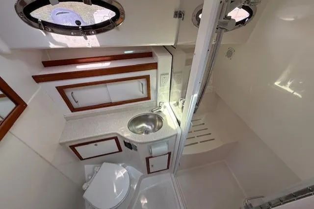Naut On Call Yacht Photos Pics 2016 Back Cove 34 yacht bathroom with sink, toilet, and shower.
