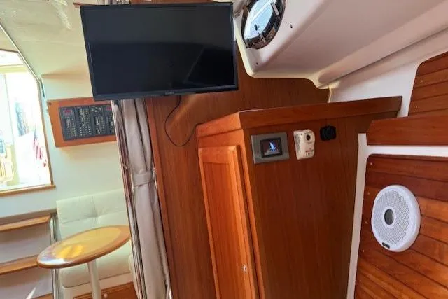 Naut On Call Yacht Photos Pics Interior of 2016 Back Cove 34 yacht with TV and wooden cabinetry.