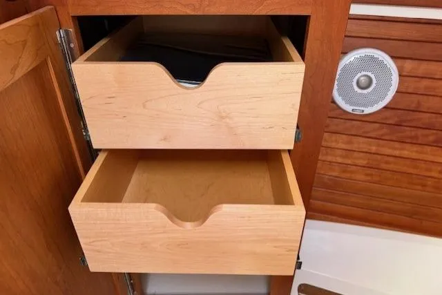 Naut On Call Yacht Photos Pics Wooden drawers in a 2016 Back Cove 34 boat interior, featuring a speaker.