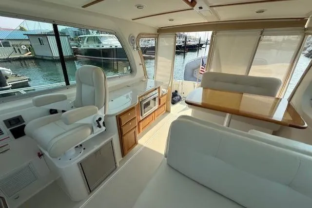 Naut On Call Yacht Photos Pics Interior of a 2016 Back Cove 34 yacht with seating, table, and helm station.