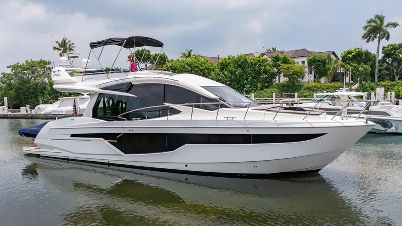 Bikini Blues Yacht Photos Pics 2017 Galeon 510 Sky yacht docked in a serene marina setting.