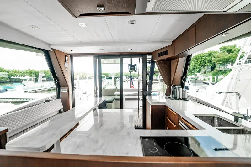 Bikini Blues Yacht Photos Pics Luxurious interior of 2017 Galeon 510 Sky yacht with modern kitchen and scenic marina view.