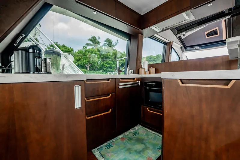 Bikini Blues Yacht Photos Pics Luxurious kitchen interior of 2017 Galeon 510 Sky yacht with modern wood cabinetry.