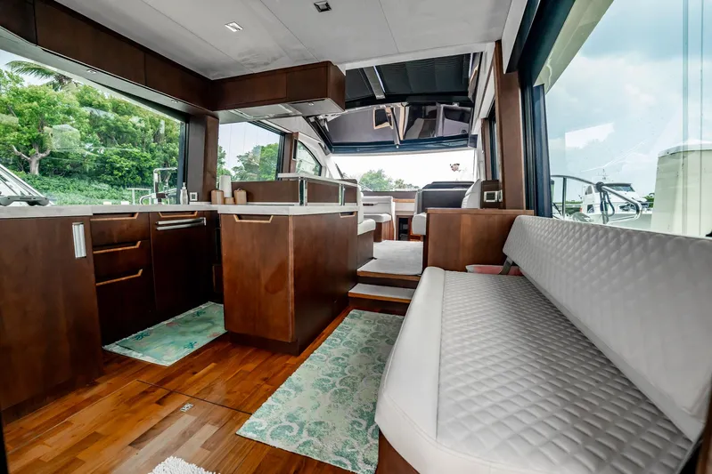 Bikini Blues Yacht Photos Pics Luxurious interior of 2017 Galeon 510 Sky yacht with modern kitchen and seating area.