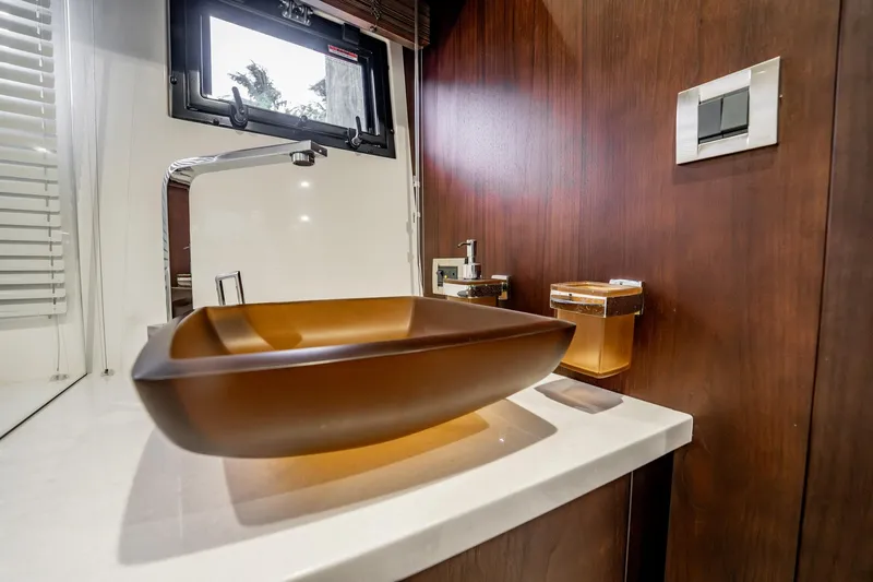 Bikini Blues Yacht Photos Pics Luxurious bathroom sink on 2017 Galeon 510 Sky yacht, featuring modern design and wood accents.