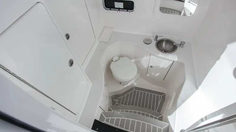 "alpha Bravo" Yacht Photos Pics 2022 Intrepid 375 Nomad SE boat interior with toilet, sink, and storage compartments.
