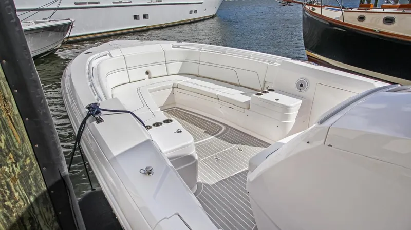 "alpha Bravo" Yacht Photos Pics 2022 Intrepid 375 Nomad SE boat with spacious seating at a dock.